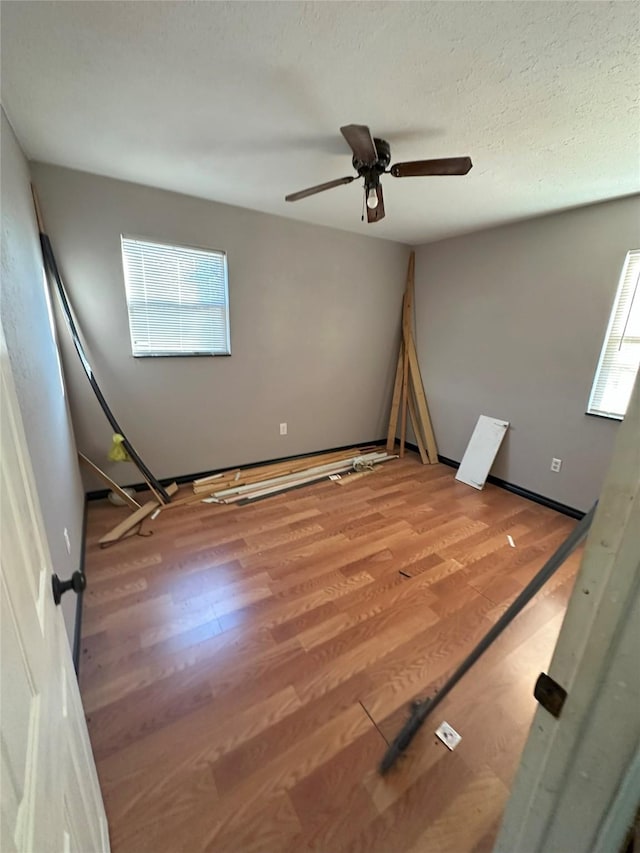 unfurnished room featuring ceiling fan and wood-type flooring