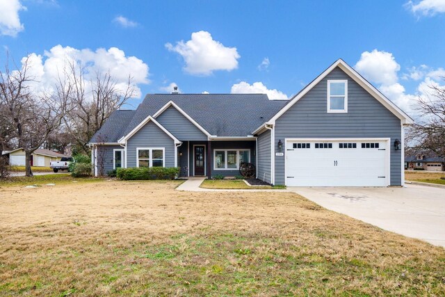 view of front facade featuring a garage and a front lawn