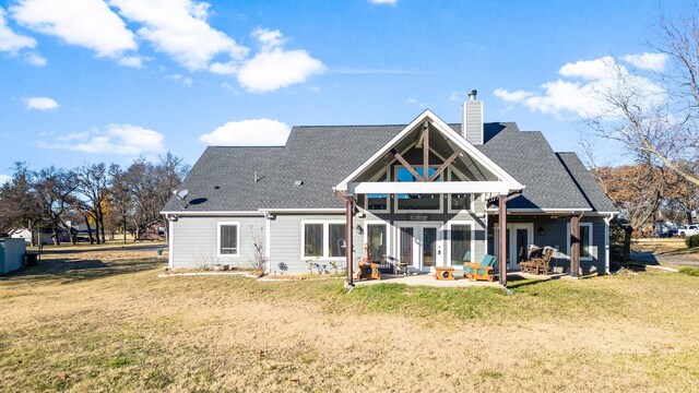 rear view of house with a yard and a patio area