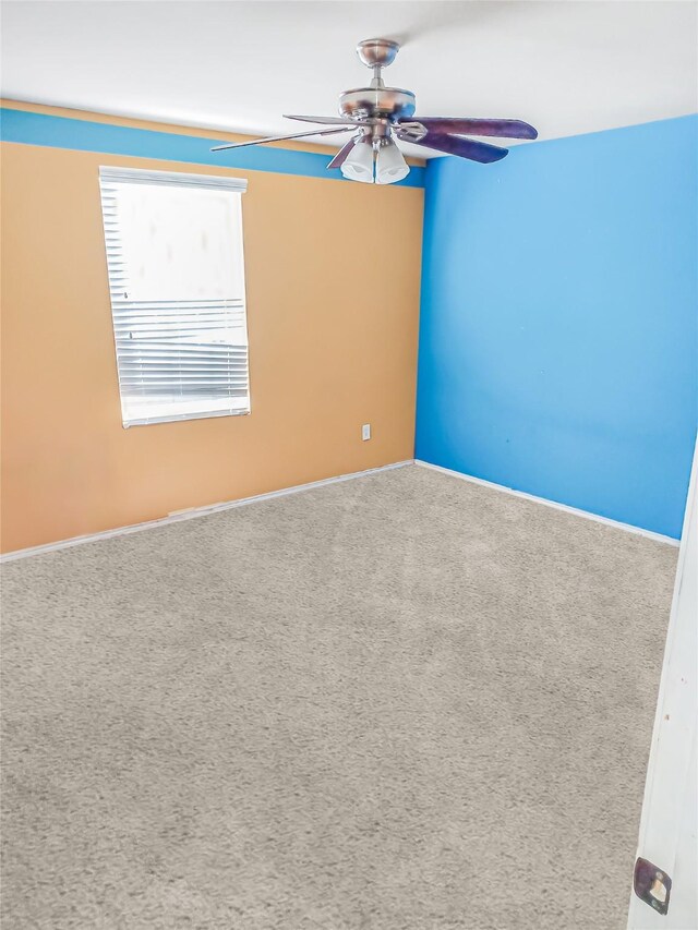 unfurnished room with ceiling fan and carpet floors