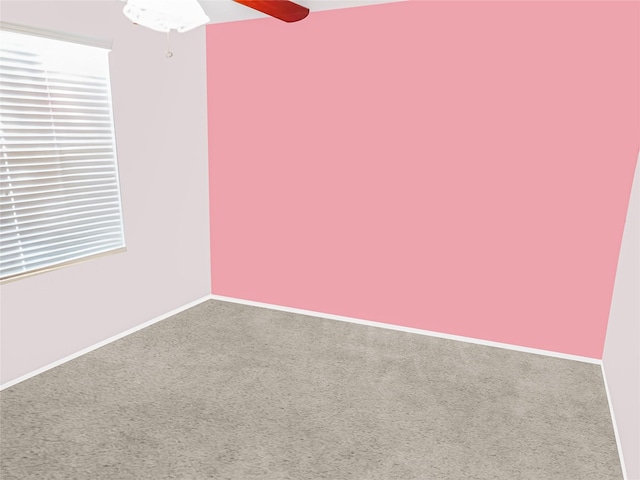 unfurnished room featuring ceiling fan and carpet floors