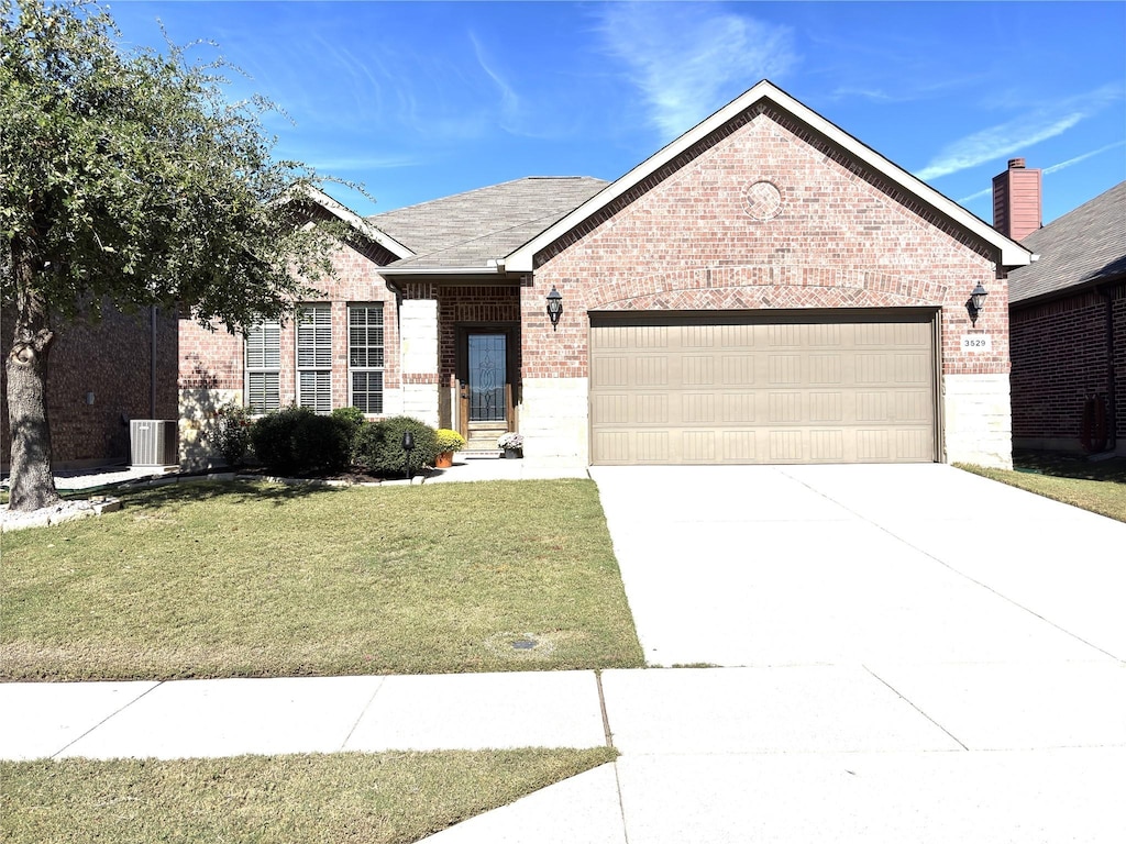 view of front of property featuring a garage and a front lawn