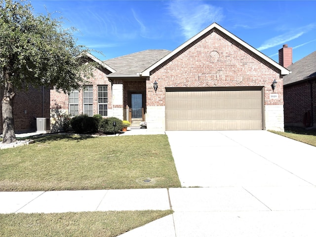 view of front of property featuring a garage and a front lawn