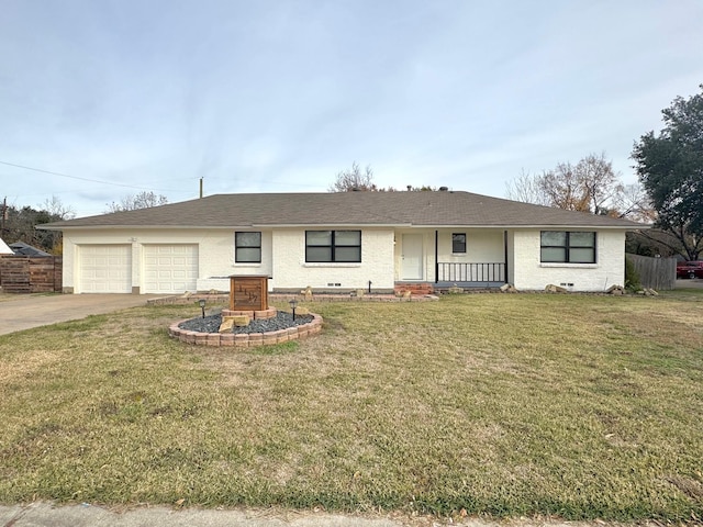 ranch-style house featuring covered porch, a garage, and a front lawn