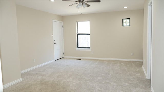 empty room with light colored carpet and ceiling fan