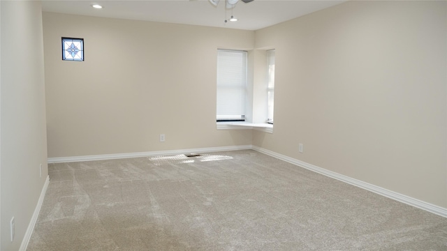 carpeted empty room with ceiling fan