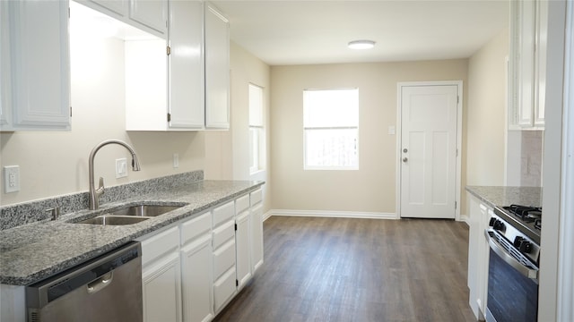 kitchen with sink, white cabinetry, dark hardwood / wood-style flooring, stainless steel appliances, and light stone countertops