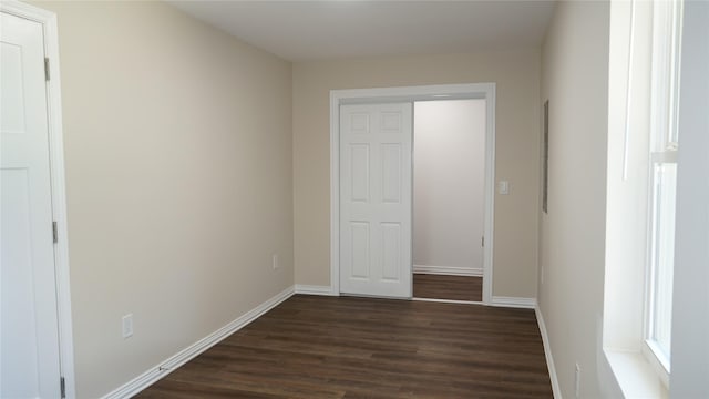 unfurnished bedroom with dark wood-type flooring