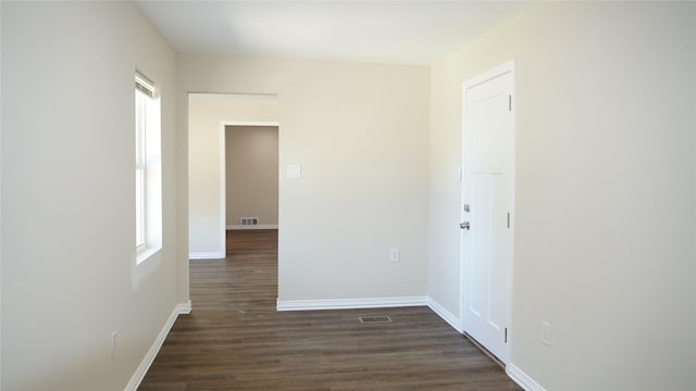 spare room featuring dark wood-type flooring