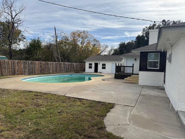 view of swimming pool with an outdoor structure and a patio area