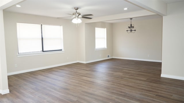 spare room featuring ceiling fan with notable chandelier and dark hardwood / wood-style floors