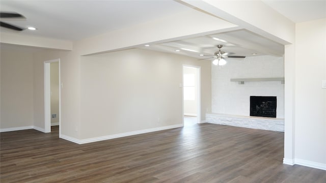 unfurnished living room featuring ceiling fan, a fireplace, and dark hardwood / wood-style flooring