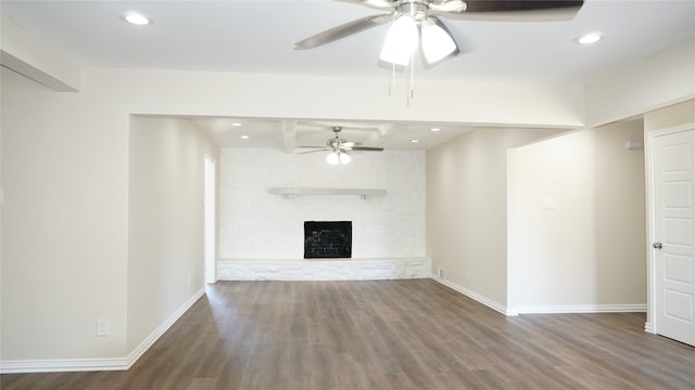 unfurnished living room featuring beam ceiling, ceiling fan, hardwood / wood-style floors, and a fireplace