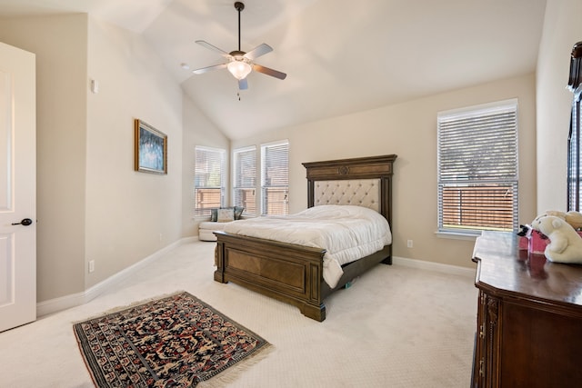 bedroom featuring multiple windows, vaulted ceiling, light colored carpet, and ceiling fan