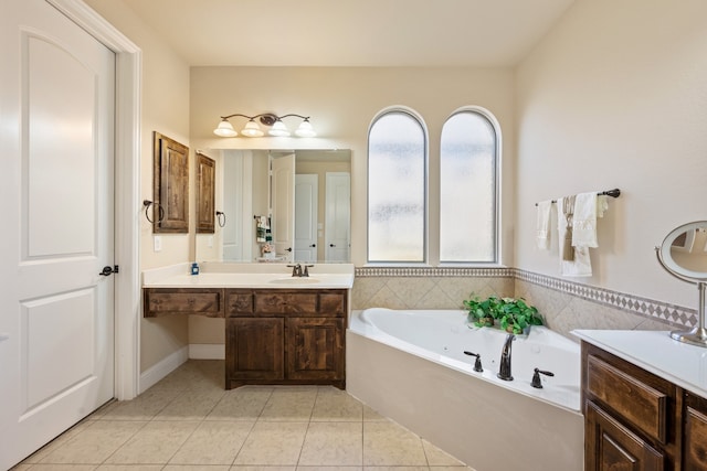 bathroom with tile patterned flooring, a bathing tub, and vanity