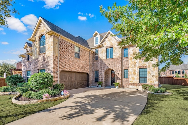 view of front of property with a garage and a front yard