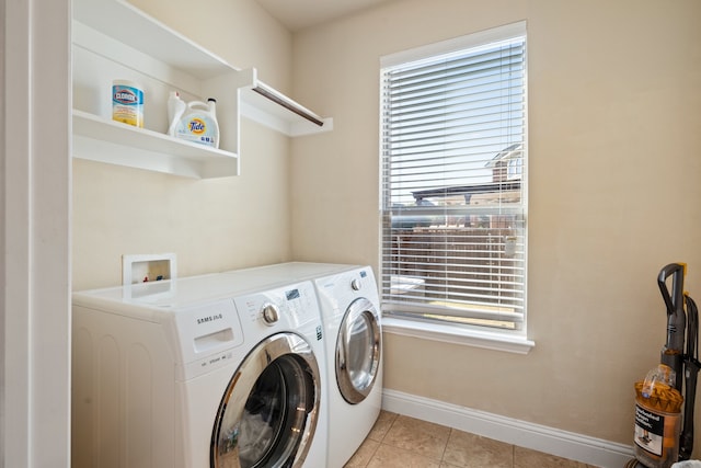 laundry room featuring plenty of natural light, separate washer and dryer, and light tile patterned floors