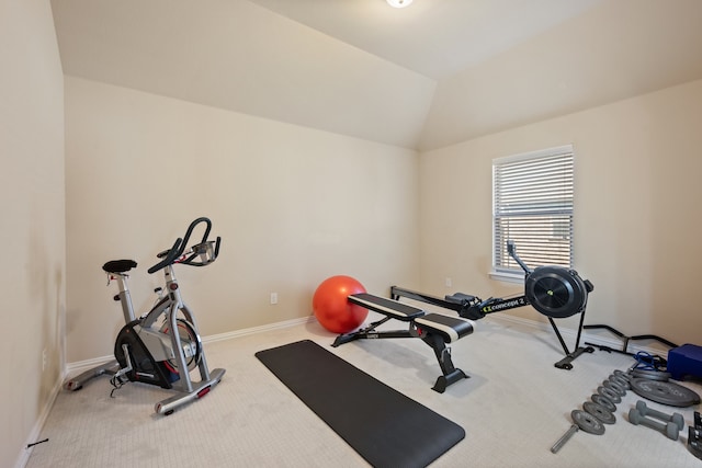 workout room featuring vaulted ceiling and carpet