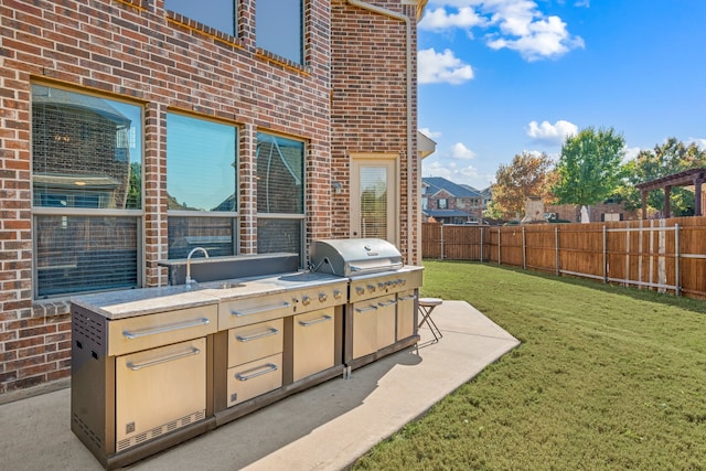 view of patio / terrace featuring area for grilling and sink