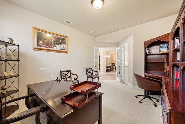 carpeted office space with french doors