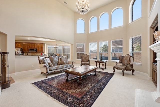 living room with light colored carpet and a chandelier