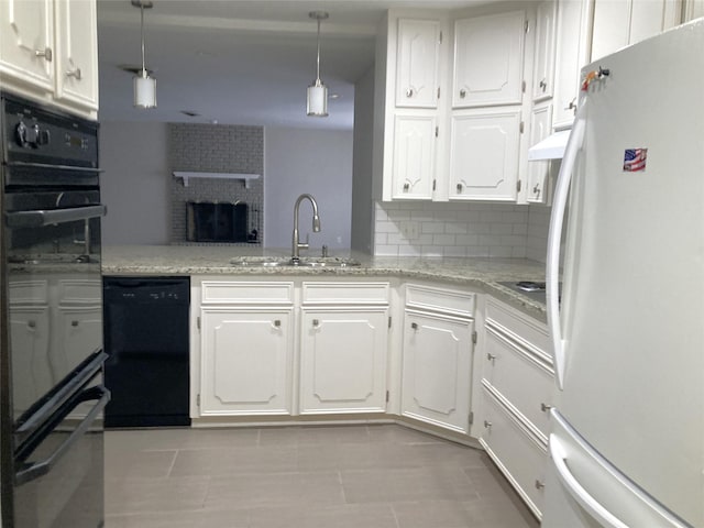 kitchen with sink, black dishwasher, white fridge, decorative light fixtures, and white cabinets