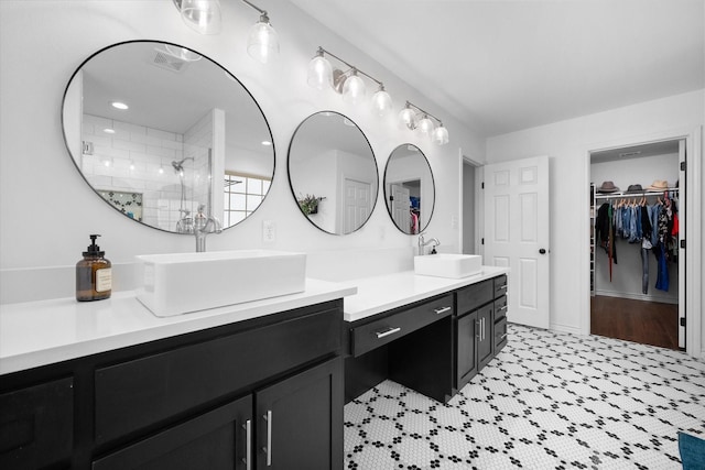 bathroom featuring vanity and tiled shower