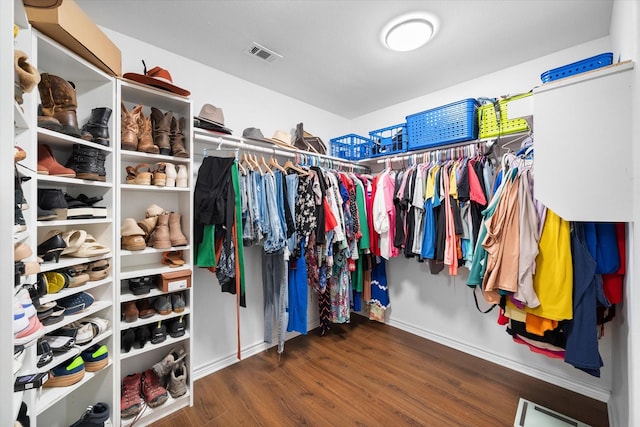 spacious closet with dark hardwood / wood-style floors