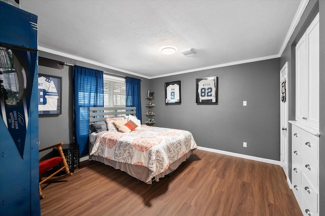 bedroom featuring ornamental molding, a textured ceiling, and dark hardwood / wood-style flooring