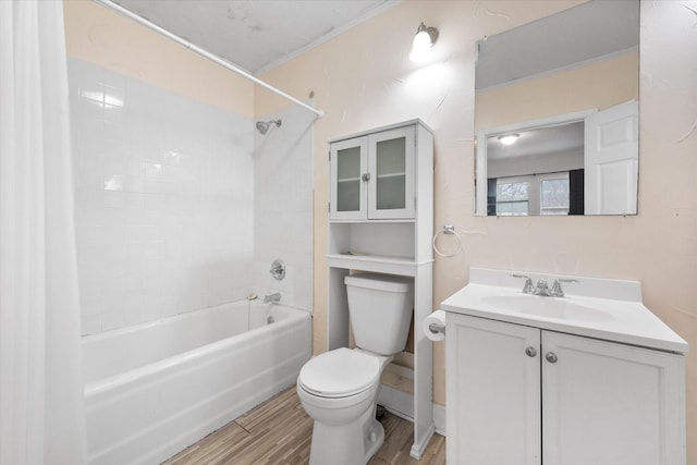 full bathroom with vanity, hardwood / wood-style floors, tiled shower / bath, and toilet