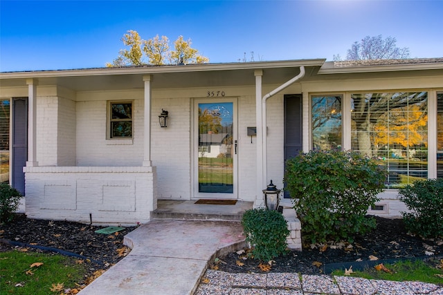 view of exterior entry with covered porch