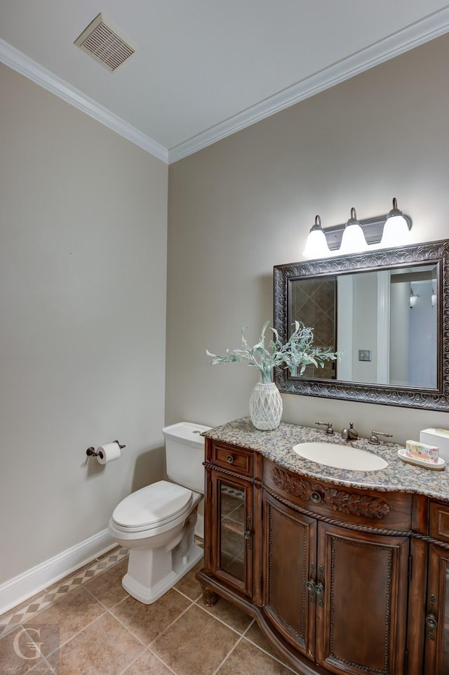 bathroom with vanity, toilet, and crown molding