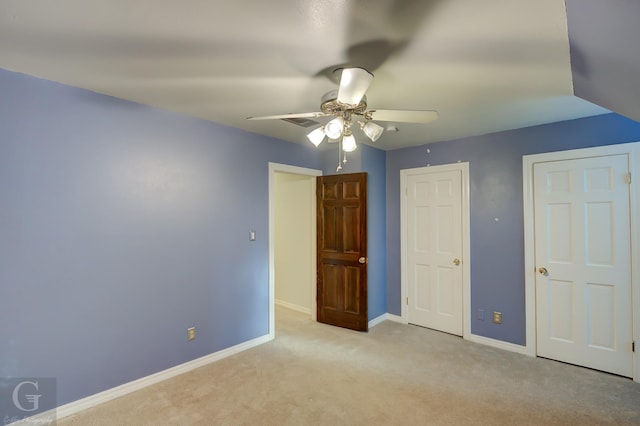 unfurnished bedroom with light colored carpet and ceiling fan