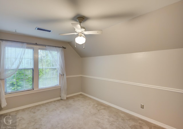 bonus room with light colored carpet, vaulted ceiling, and ceiling fan