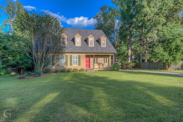 new england style home featuring a front yard