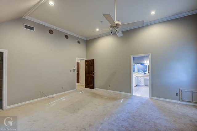 spare room featuring ceiling fan, crown molding, high vaulted ceiling, and light carpet