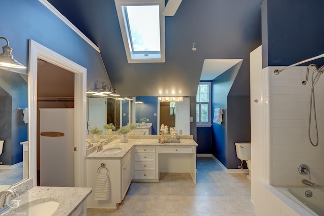 bathroom featuring vanity, tiled shower / bath combo, lofted ceiling with skylight, and a healthy amount of sunlight