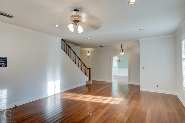 unfurnished room with ceiling fan with notable chandelier, hardwood / wood-style flooring, and ornamental molding