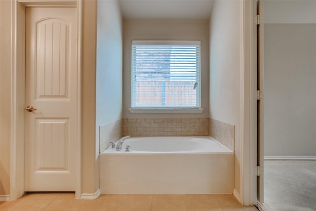 bathroom with tile patterned floors and a tub