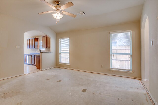 unfurnished living room with lofted ceiling, sink, and ceiling fan