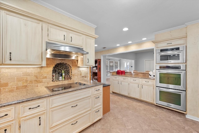 kitchen featuring crown molding, black electric stovetop, double oven, and tasteful backsplash