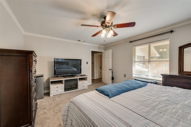 bedroom featuring crown molding, ceiling fan, and light carpet