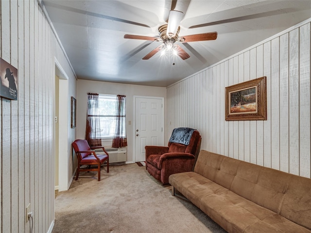 carpeted living room with an AC wall unit and ceiling fan