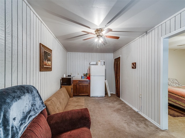 interior space with ceiling fan and light colored carpet