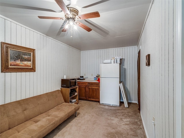 carpeted living room with ceiling fan