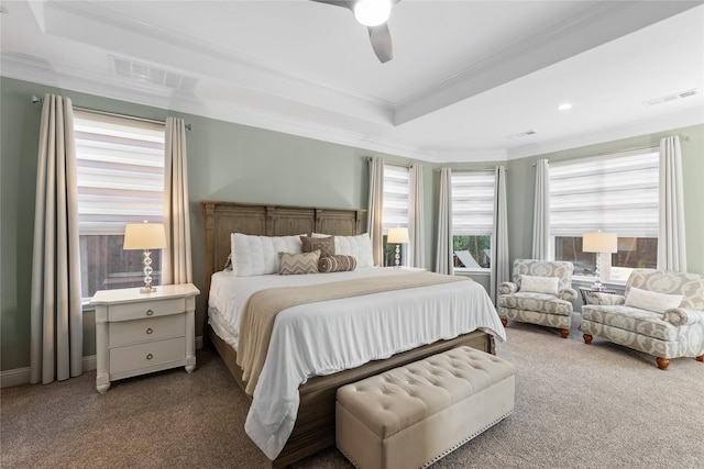 bedroom featuring dark colored carpet, ceiling fan, crown molding, and a tray ceiling