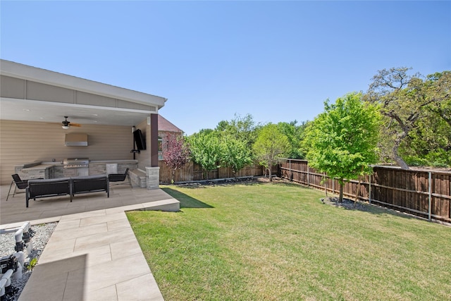 view of yard featuring a patio, ceiling fan, exterior kitchen, a fenced backyard, and outdoor lounge area