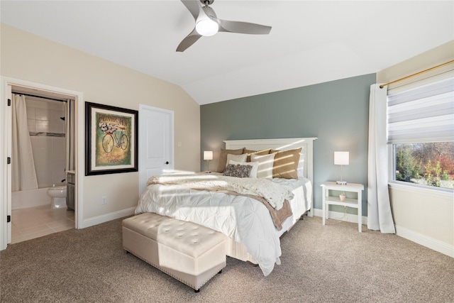 carpeted bedroom featuring ceiling fan, ensuite bathroom, and lofted ceiling