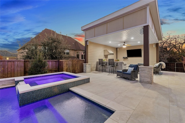 view of pool with an in ground hot tub, ceiling fan, an outdoor bar, and a patio