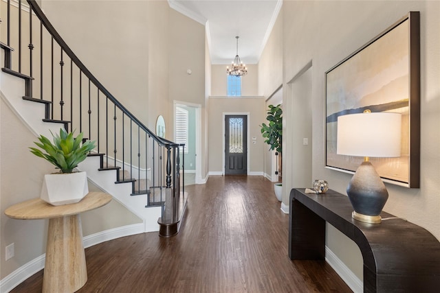 foyer featuring dark wood finished floors, baseboards, and stairway